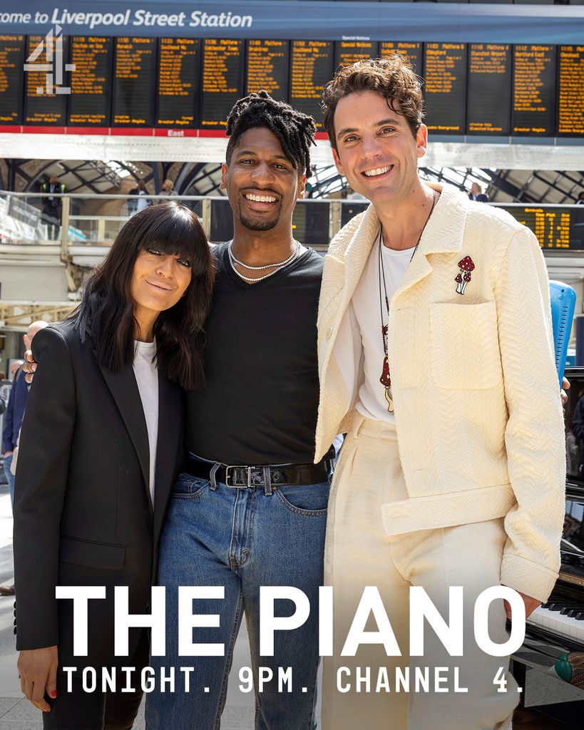 a woman and two men standing in train station