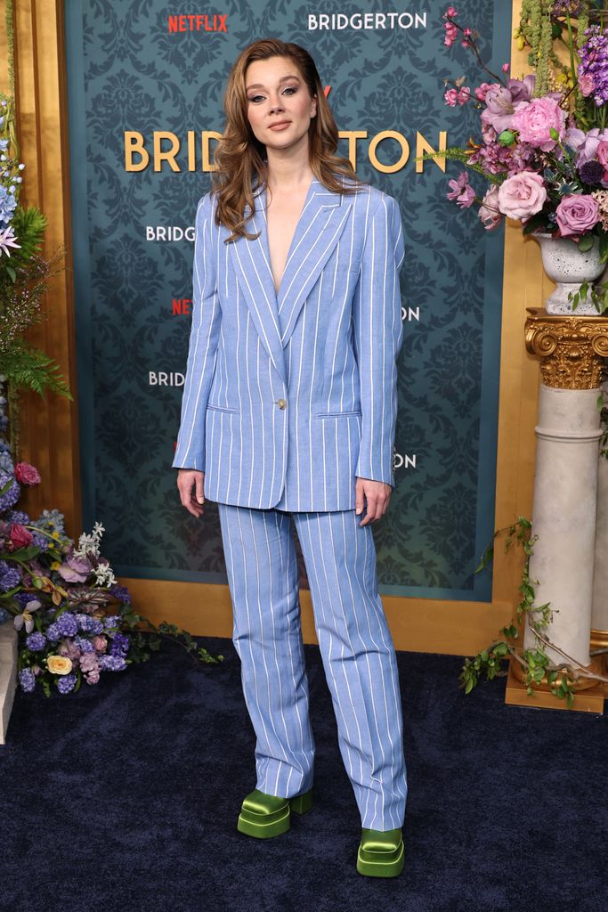 Claudia wore the pale blue and white pinstriped suit teamed with green satin platforms for the Bridgerton World Premiere in New York. 