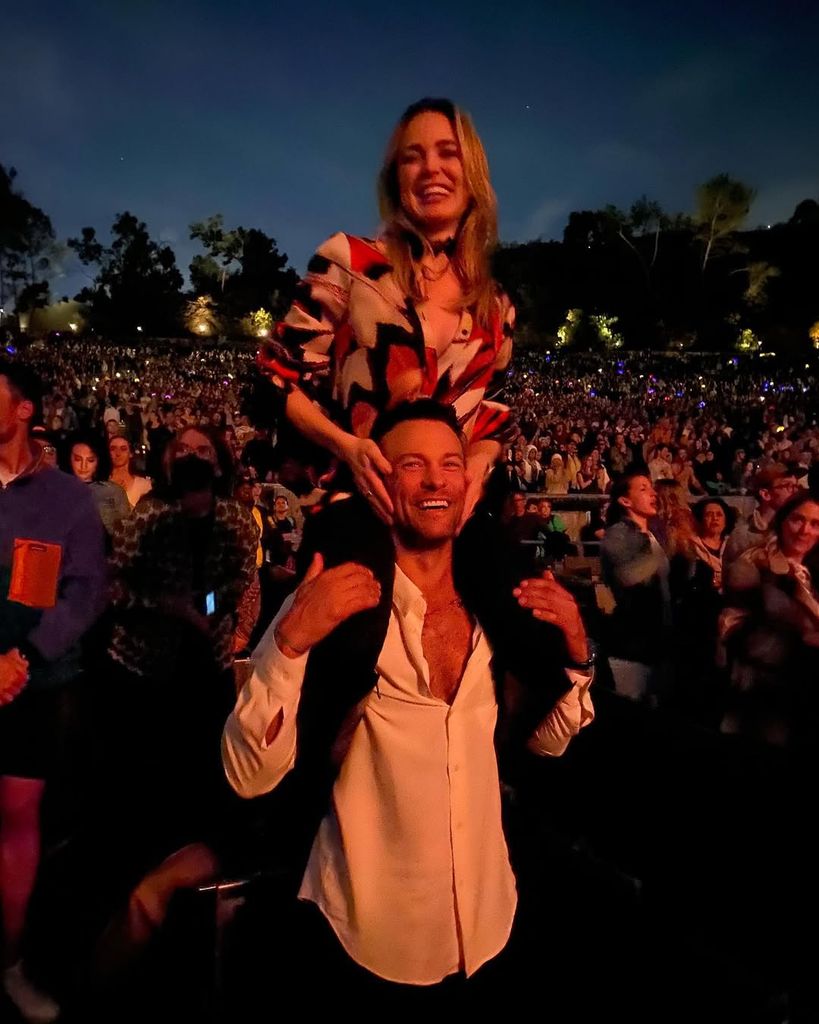 Kyle Schmid carries Caity Lotz on his shouders at the Hollywood Bowl