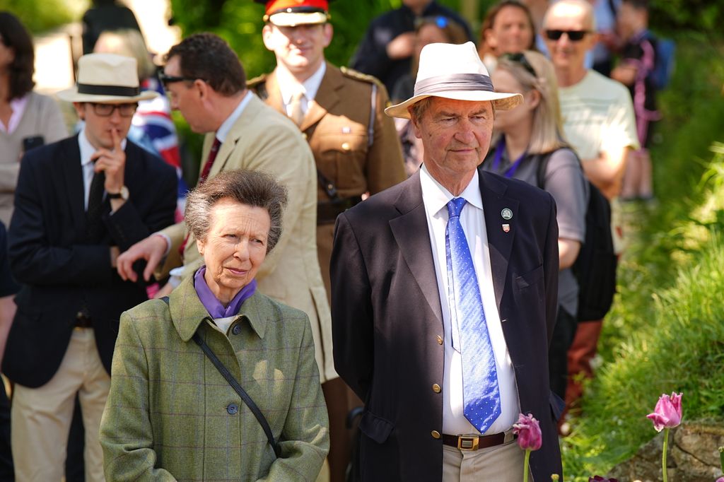 Princess Anne and Vice Admiral Sir Timothy Laurence watches a children's performance as she attends commemorations in Sark