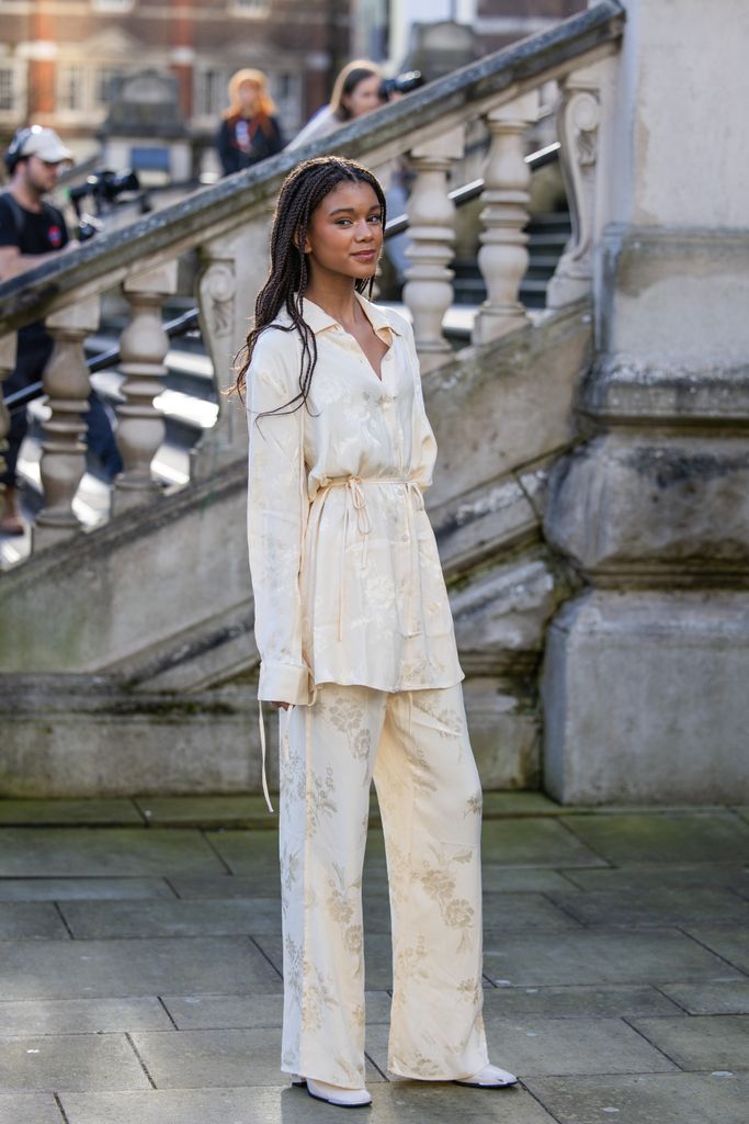 LONDON, ENGLAND - FEBRUARY 18: A guest wears creme white shirt, pants with print outside Holzweiler during London Fashion Week February 2024 on February 18, 2024 in London, England. (Photo by Christian Vierig/Getty Images)