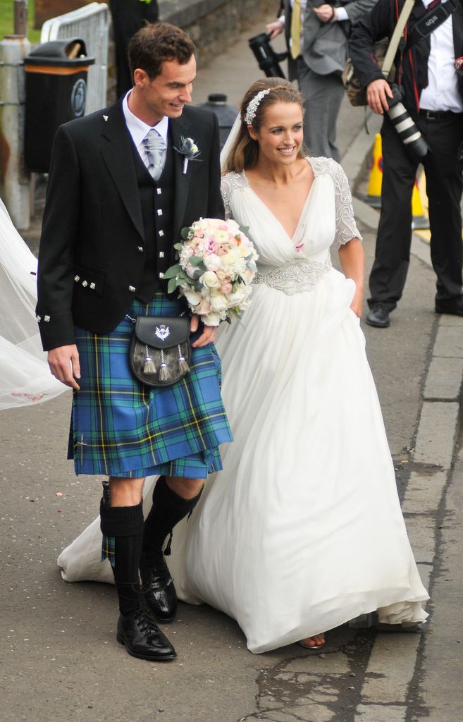 Kim Murray in v neck wedding dress veil and headband marrying Andy Murray at Dunblane Cathedral