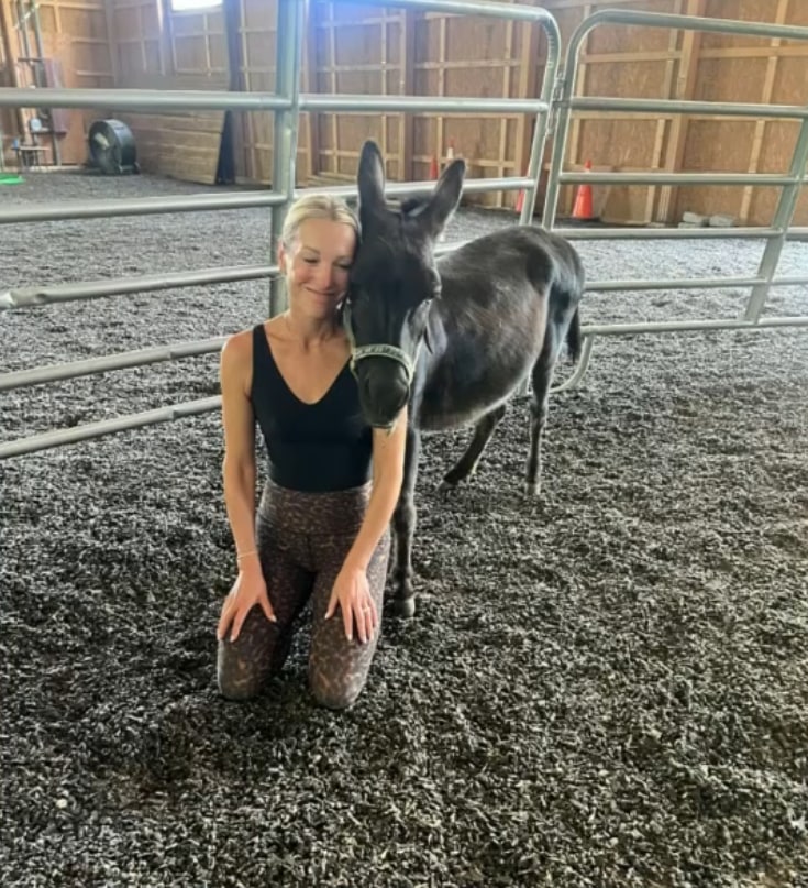 Photo shared by Craig Melvin on TODAY of his wife Lindsay Czarniak posing next to a donkey while on a wellness retreat