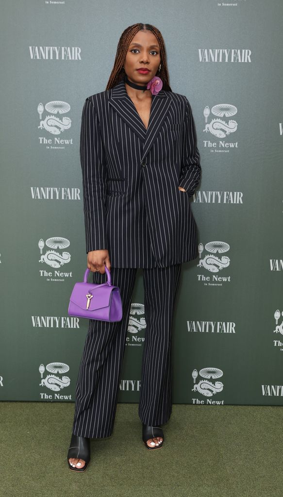 Seun Ogunsola wears a pinstripe suit with a floral choker 