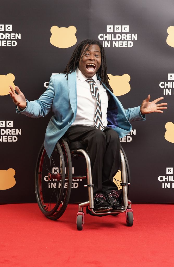 Ade Adepitan poses on red carpet at Children in Need