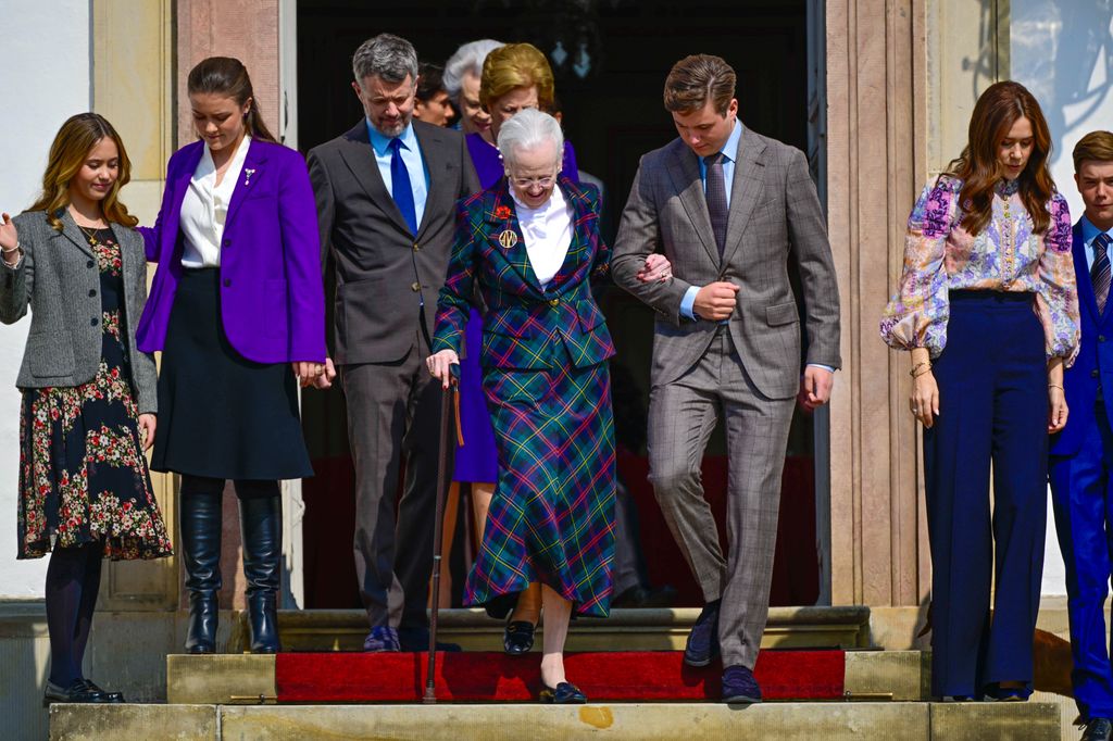 Crown Prince Christian helps Queen Margrethe down the steps
