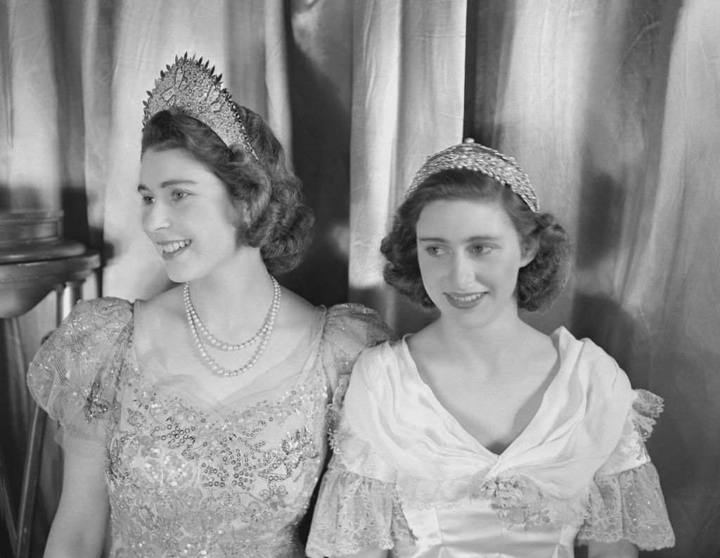 Princess Elizabeth (Queen Elizabeth II) and Princess Margaret (1930-2002), both dressed in elaborate gowns, pictured during a royal pantomime production of 'Old Mother Red Riding Boots' at Windsor Castle, Berkshire, Great Britain, 22 December 1944