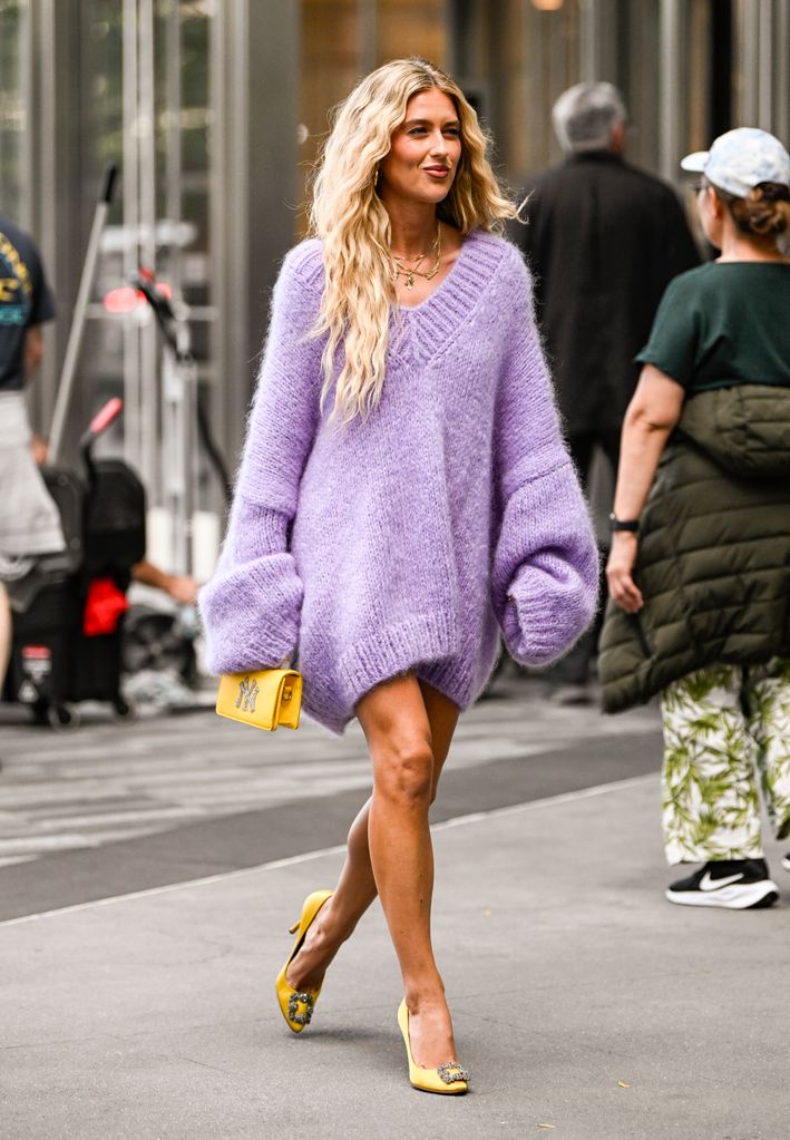 Emili Sindlev is seen wearing a purple Michael Kors sweater and yellow Michael Kors bag outside the Michael Kors show during NYFW Spring/Summer 2025 on September 10, 2024 in New York City.