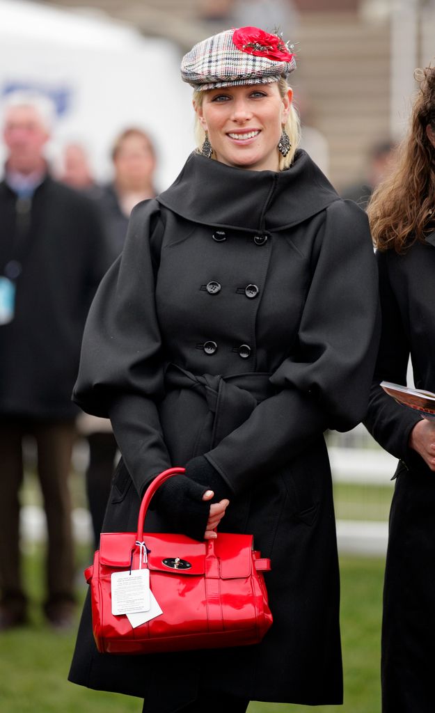 zara in black coat with tartan flat cap