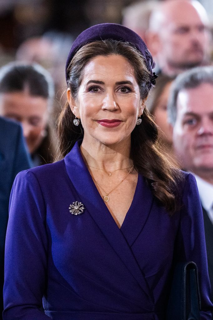 Queen Mary in purple with fascinator