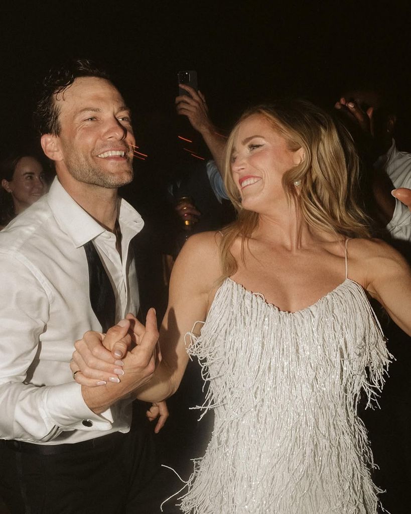 Kyle Schmid and Caity Lotz dance during their wedding reception