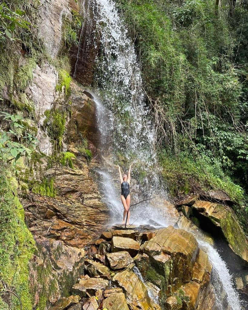 Gisele poses in a swimsuit by a waterfall