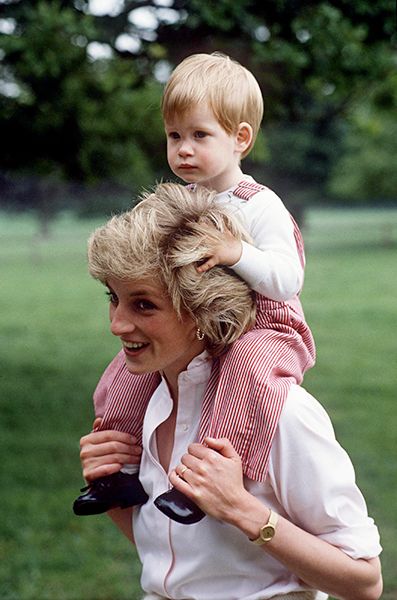 Baby Prince Harry sat on Princess Diana shoulders