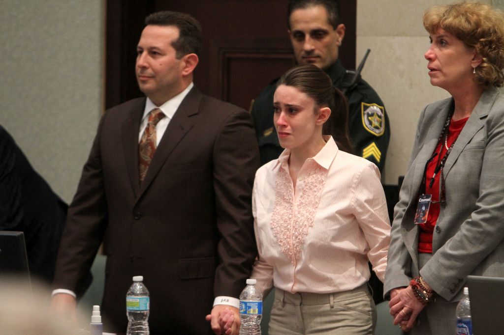 Casey Anthony reacts to being found not guilty on murder charges at the Orange County Courthouse on July 5, 2011 in Orlando, Florida.  At left is her attorney Jose Baez. On the right is attorney Dorothy Clay Sims. Casey Anthony had been accused  of murdering her two-year-old daughter Caylee in 2008