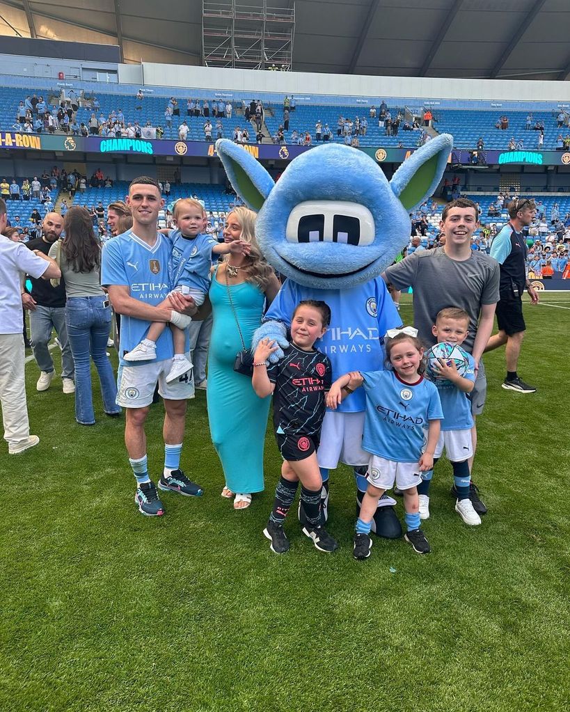 Phil Foden with his kids and partner Rebecca on the football pitch