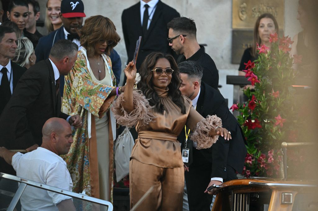 US TV host Oprah Winfrey (C) and US journalist Gayle King leave the Gritti Palace Hotel for a party on the third day of the wedding of US Amazon founder Jeff Bezos with Lauren Sanchez