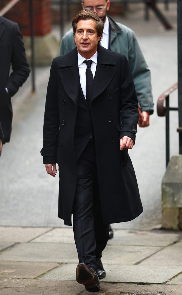 David Sherborne walking in black coat