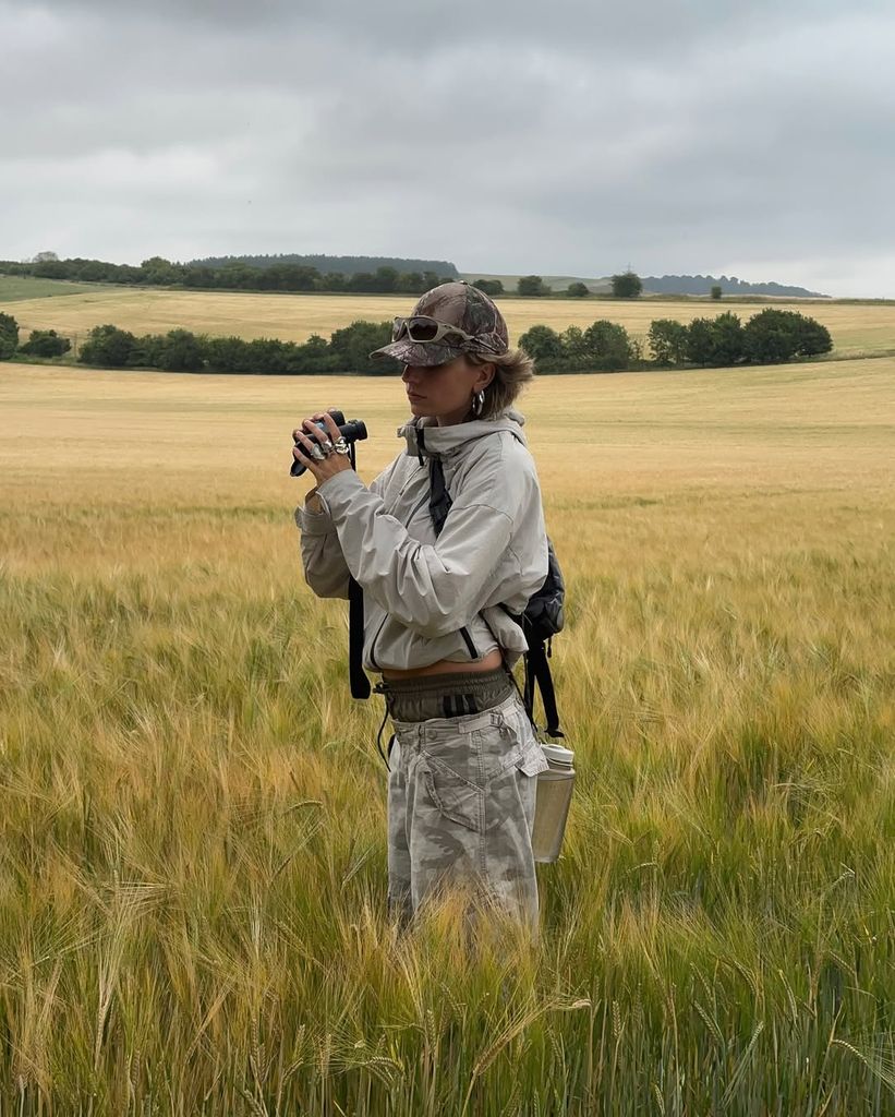 momentsabloom wears grey waterproof jacket and camo pants