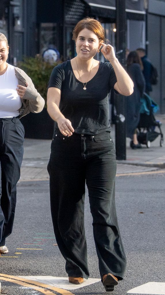 Princess Eugenie with her hand behind her ear