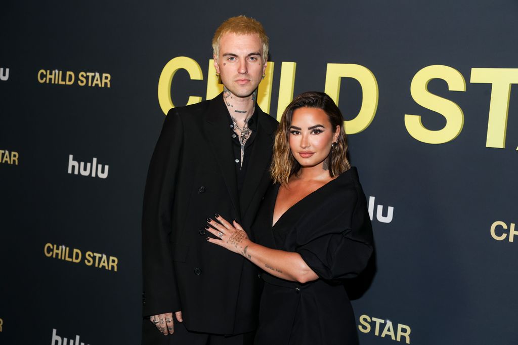 Demi Lovato and Jordan Lutes hug red carpet