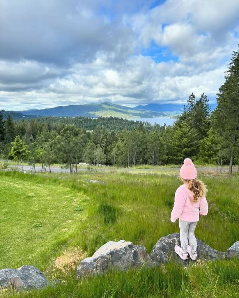 Chris Pratt's daughter in a pink jacket and bobble hat in the countryside