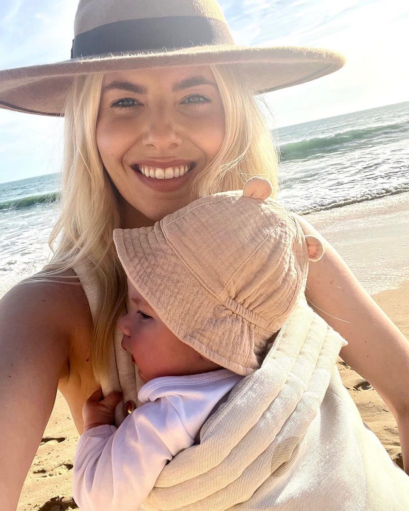 Mollie on beach with baby in sling