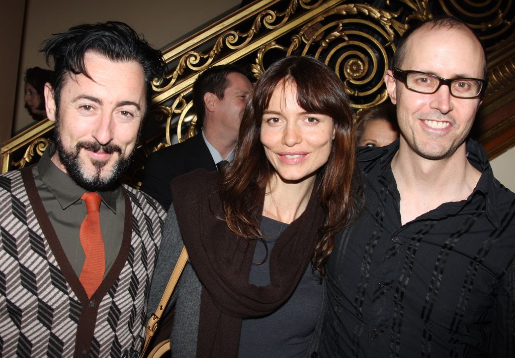 Alan Cumming standing with Saffron Burrows and Grant Shaffer