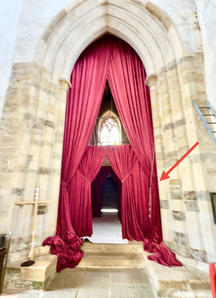 A large piece of red fabric over a church door