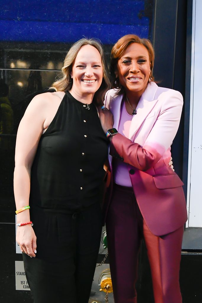 Amber Laign and Robin Roberts celebrate Robin Roberts' 20th "GMA" anniversary outside "Good Morning America" on April 14, 2022 in New York City