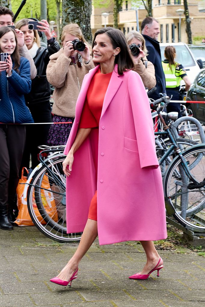Queen Letizia walking in a Barbie pink coat and heels