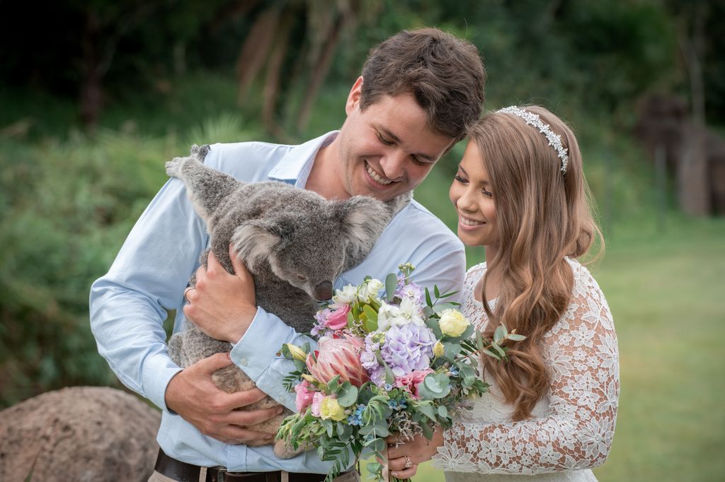 Bindi Irwin and Chandler cuddle a koala on their wedding day