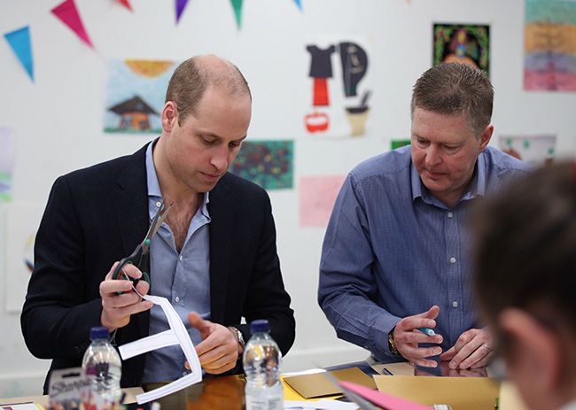 Prince William alongside Mick Clarke taking part in an arts and craft session 