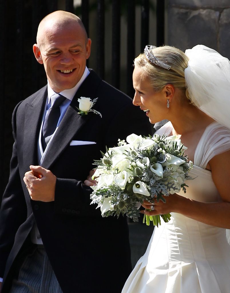 Mike Tindall looking at his wife Zara Phillips on their wedding day