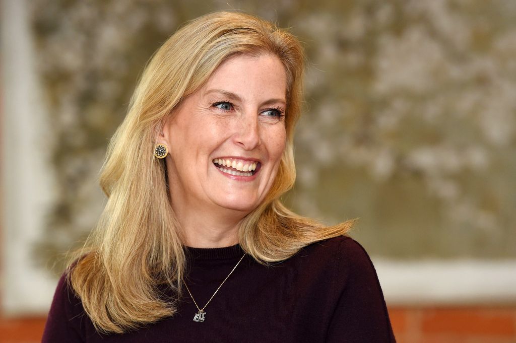Duchess Sophie smiling and looking to the side wearing a dark jumper