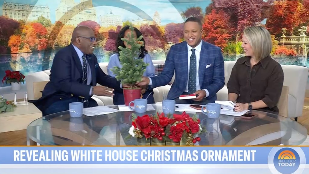 Al Roker giving Craig Melvin a mini Christmas tree in studio