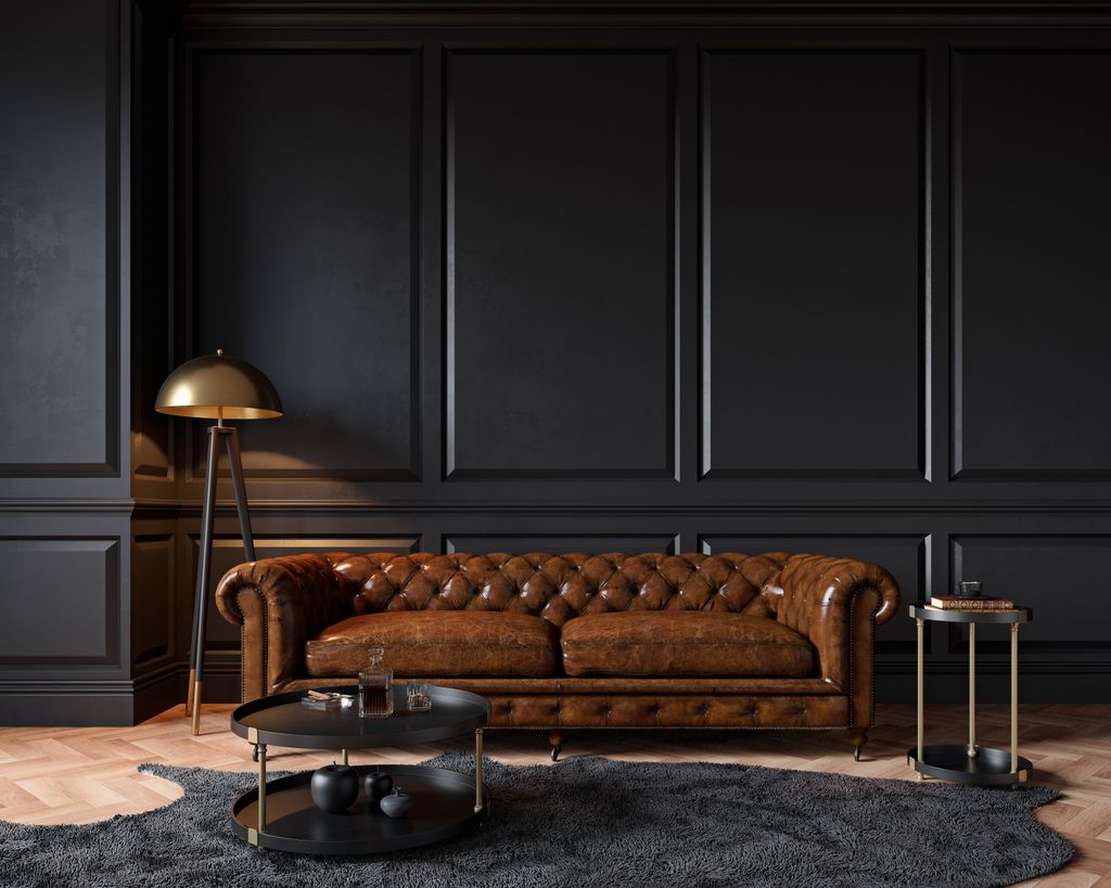 Dark living room with a brown sofa