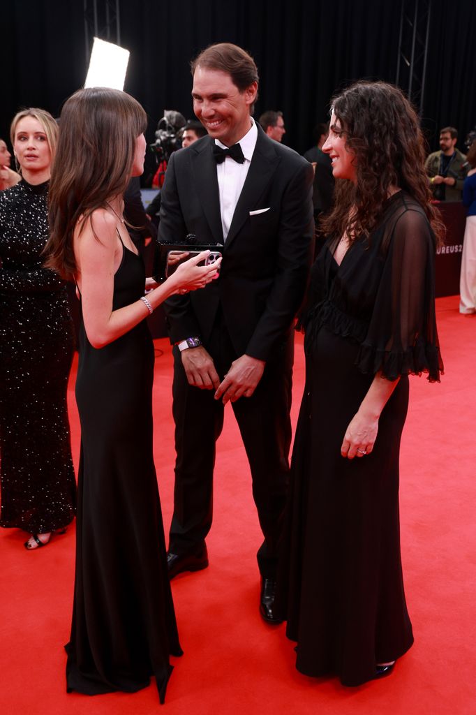 Rafael Nadal in a tux and his wife in a black dress with a baby bump