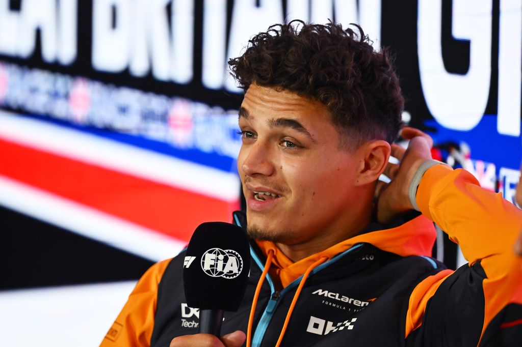 Lando Norris holding a microphone