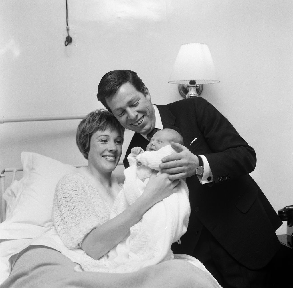 Julie Andrews of 'My Fair Lady' fame pictured in the London Clinic with her new baby daughter Emma. It was also announced today that Julie will make her film debut in Walt Disney's 'Mary Poppins.' Also pictured is Julie's husband, stage designer Tony Walton, 28th November 1962