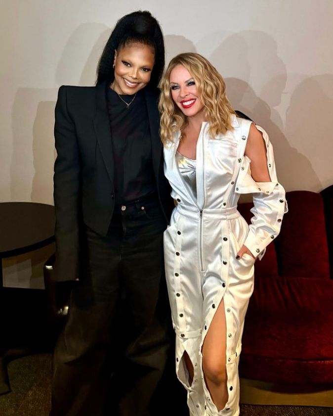 Janet Jackson in a black outfit and Kylie Minogue in a silver outfit