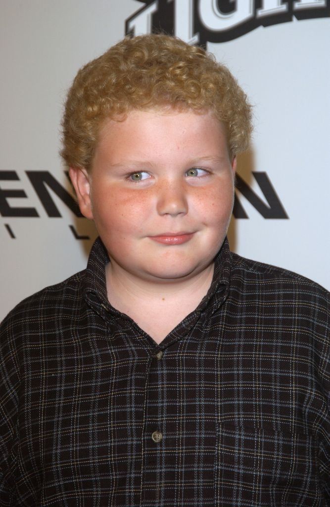 Brett with curly. hair and checked shirt as a kid