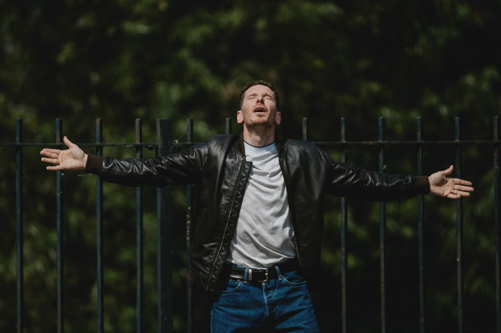 Gerard Kearns in a leather jacket with his arms outstretched in a scene from Waiting for the Out