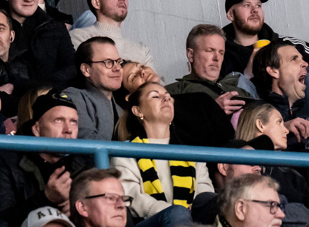 couple sharing sweet moment during hockey game