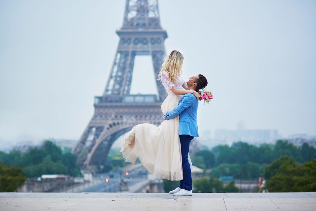 A just married couple in front of the Eiffel Tower in Paris