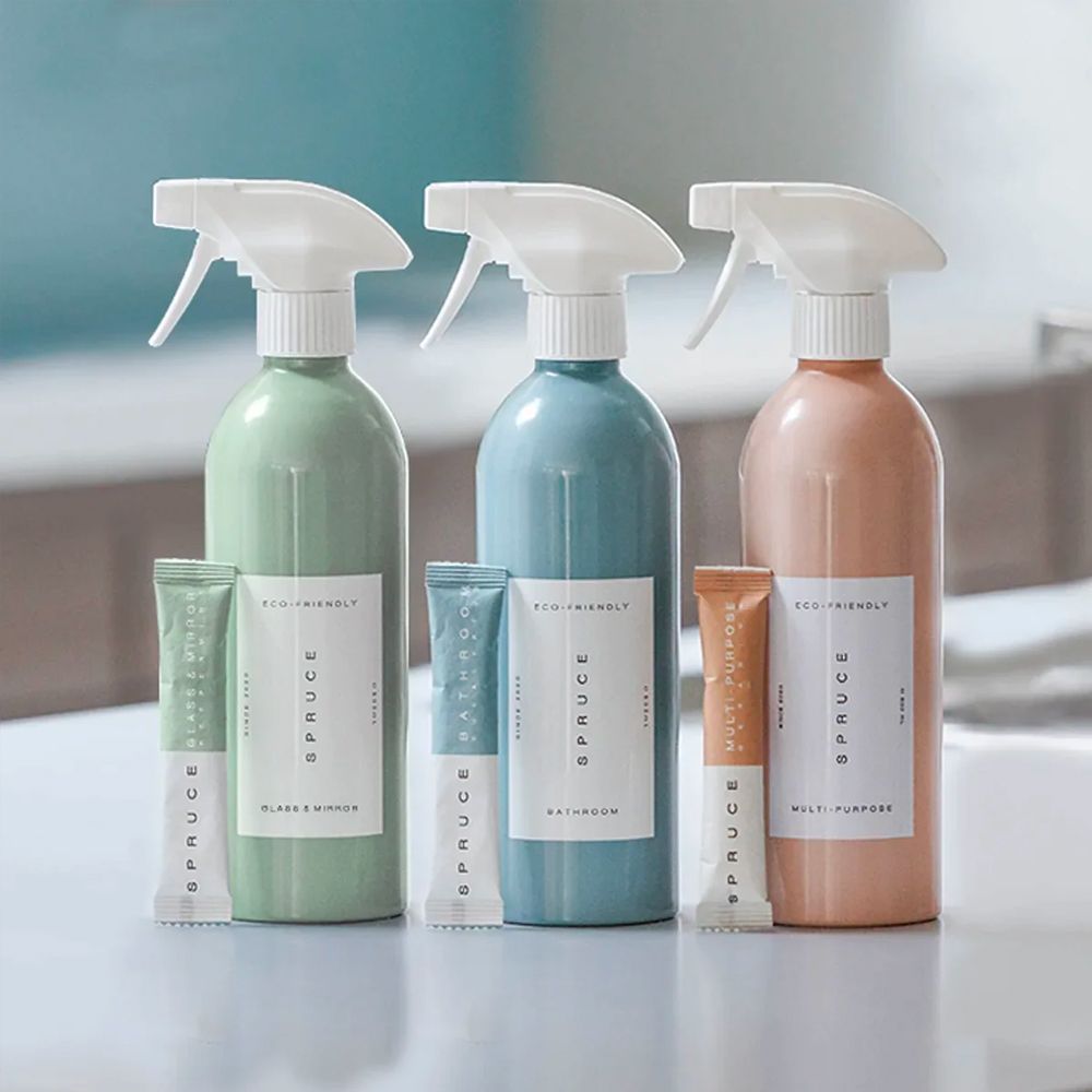 Green, blue and pink cleaning sprays from Spruce