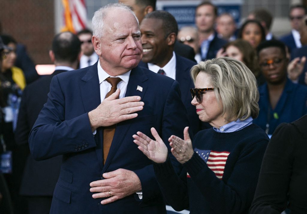 Minnesota Governor and Democratic vice presidential candidate Tim Walz and his wife Gwen Walz gesture at supporters ahead of US Vice President Democratic presidential candidate Kamala Harris speech at Howard University in Washington, DC, on November 6, 2024