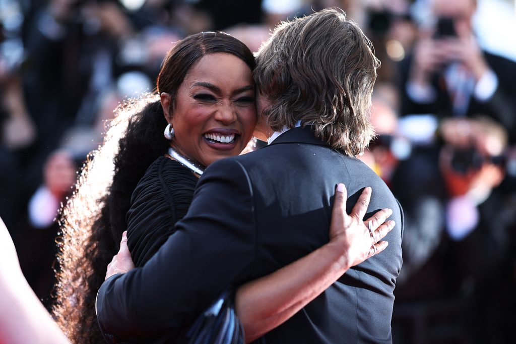 US actress Angela Bassett embraces US actor and producer Tom Cruise arrives for the screening of the film "Mission: Impossible - The Final Reckoning" 