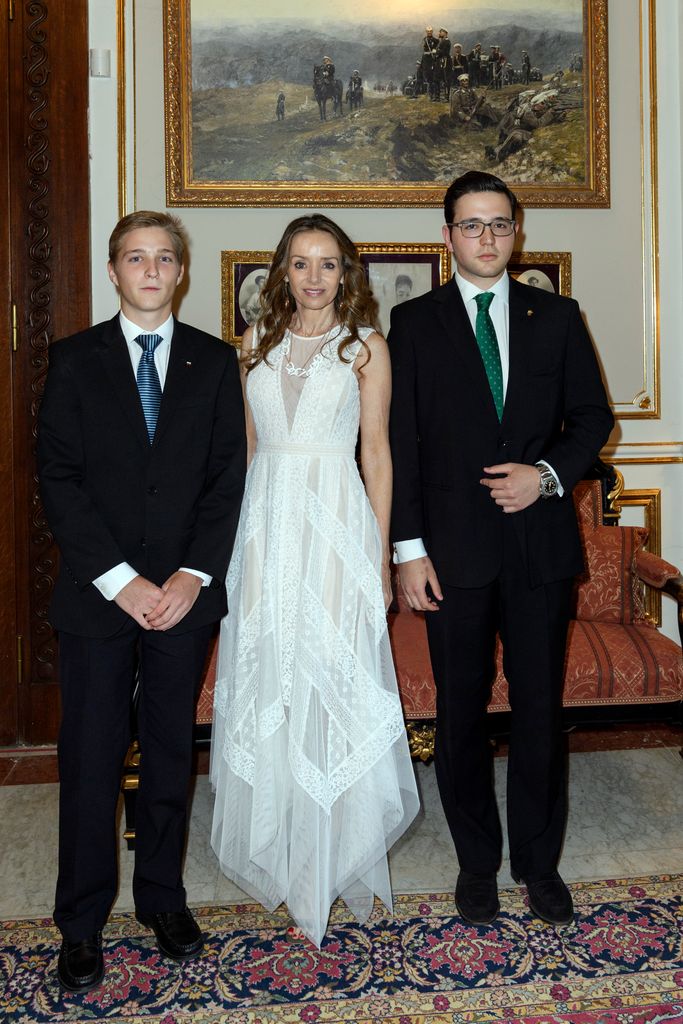 Prince Beltran and Prince Boris in suits and Princess Miriam in a white dress