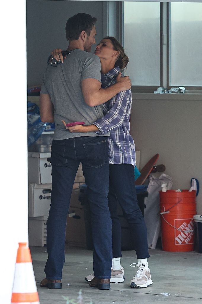 Jennifer and John looked smitten hugging 