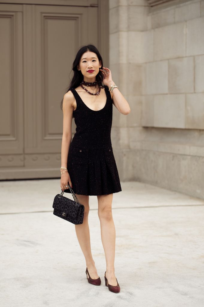 Rebecca Ma wears black mini dress and black Chanel bag with flowers pattern and black necklace outside Chanel show during the Haute Couture Fall/Winter 2025/2026 as part of Paris Fashion Week